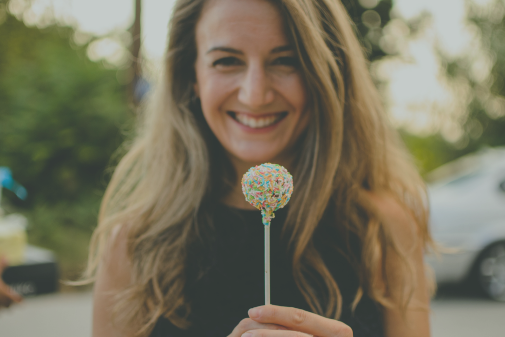 Image of Woman holding a lolipop for "Why Insulin Resistance Is Affecting Your Weight Loss" Blog Post