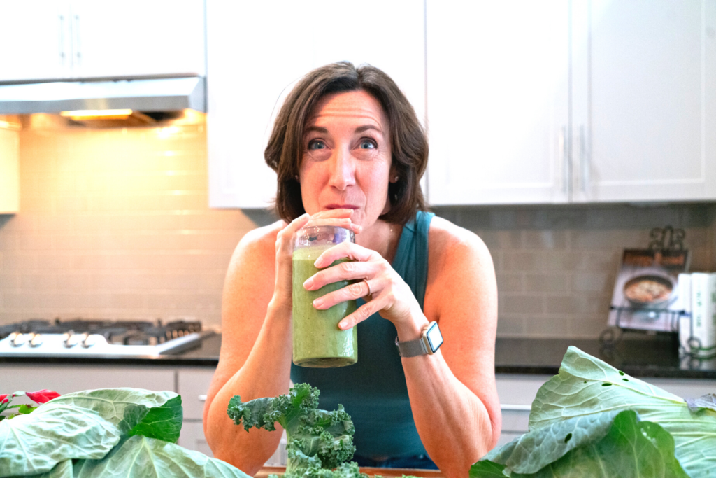 Image of Ann Hackman drinking green juice for "6 Ways To Naturally Boost Your Immunity" Blog Post