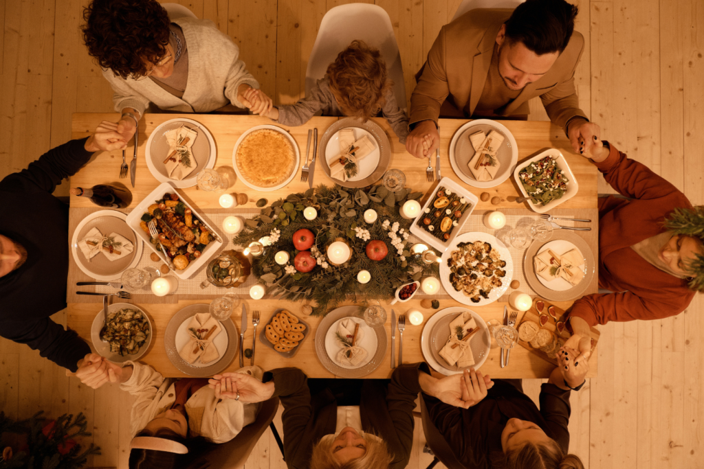 Image of Saying grace at the table with the whole family for "The Holiday Health Cues You Need To Know About" blog Posts